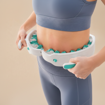 Person using a manual massage roller on their abdomen against a beige background